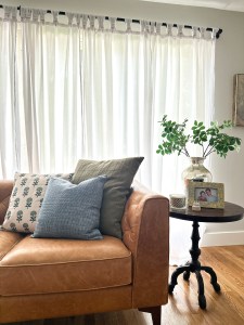 photo may contain living room with leather couch and iron side table
